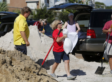 The rush on batteries, flashlights, plastic tarps and sandbags began on Friday.