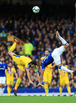 Palace's James Tomkins (left) and Everton's Richarlison tumble after challenging for the ball.