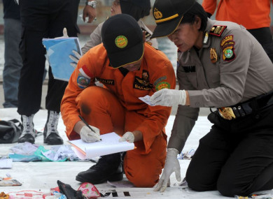 Search and Rescue members and police officers check belongings of Lion Air flight JT 610 victims in Jakarta today.