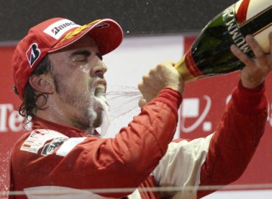 Ferrari's Fernando Alonso celebrates his win at the Singapore Grand Prix yesterday.