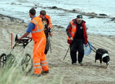 Investigators begin their search for the remains of Peter Wilson on a beach at Waterfoot, Co Antrim.