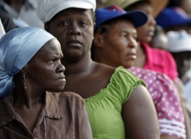 Women wait in line to cast their ballots outside a polling station in Port-au-Prince today.