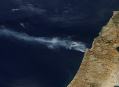 Satellite image released by NASA shows smoke drifting away from the fires outside Haifa, Israel.