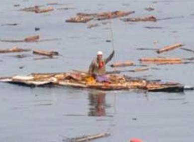 80-year-old Hiromitsu Shinkawa waves to rescuers, after spending two days floating on what used to be the roof of his house.
