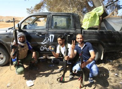Rebels rest after clashes with pro-Gadaffi forces.