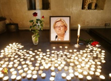 Candles surround an image of the late Anna Lindh after her murder in 2003..