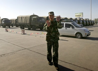 File photo of a soldier approaching a photographer as a military convoy passes through Kashgar, China.