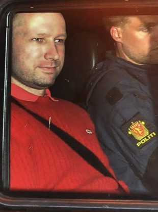 Anders Behring Breivik, left, sits in an armored police vehicle after leaving the courthouse following a hearing in Oslo.