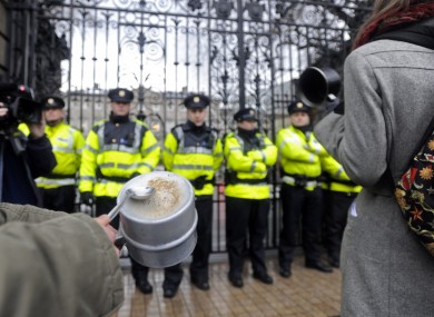 A protestor bangs a tin cup outside Leinster House on Budget Day last year