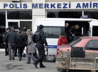 Passengers of the hijacked boat return to a security office in Silivri.