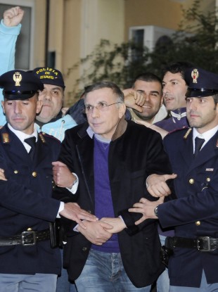 Policemen escort fugitive mobster Michele Zagaria, center, at the police headquarters in Naples.
