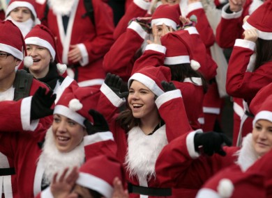 People dressed as Father Christmas take part in the Great Edinburgh Santa Run earlier today