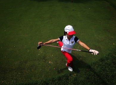 Ada Li, 11, stretching before her round of golf.