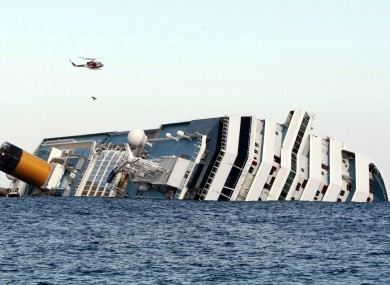 An Italian firefighter helicopter lifts up a passenger from the luxury cruise ship Costa Concordia