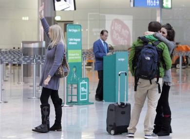 Bernadette Kelly from Foxrock wave goodbye as her daughter Anne and her three grandchildren disappear through security today at Dublin Airport.