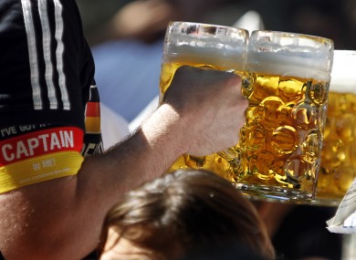 A German supporter carries beer glasses at the last World Cup in South Africa.