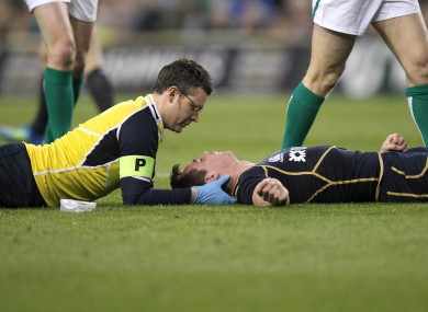 Jones is carefully treated by Scottish team doctors during a lengthy delay in the second half of yesterday's Six Nations match.