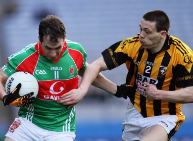 Crossmaglen Rangers' James Morgan tackles Dessie Dolan of Garrycastle.