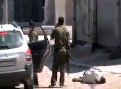 This image made from amateur video and released by Syrian Media Centre Friday, April 13, 2012 purports to show a dead body next to Syrian soldiers in Daraa, Syria