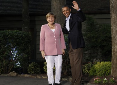 President Barack Obama greets German Chancellor Angela Merkel on arrival for the G8 Summit Friday, May 18, 2012