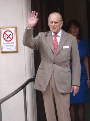 The Duke of Edinburgh waves as he leaves the Central London hospital this morning.