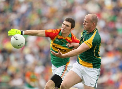 Carlow's Conor Lawlor and Joe Sheridan of Meath contest a loose ball.