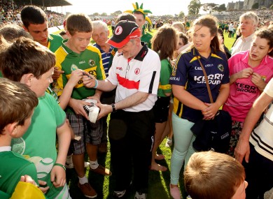 Solidarity: Tyrone manager Mickey Harte signs autographs after Saturday's defeat in Killarney.