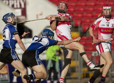 Sarsfields Daniel Roche and Conor O'Sullivan and De La Salle's John Mullane in action two years ago.