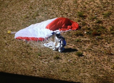 Felix Baumgartner touches down in New Mexico after jumping from 24.2 miles above ground - a new world record.