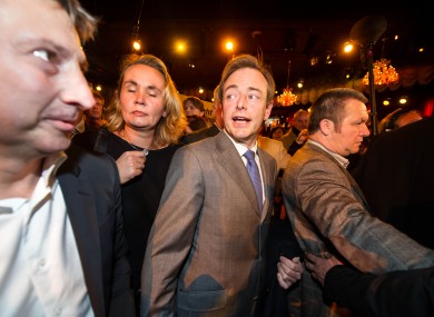 Leader of the NV-A party Bart De Wever, center, arrives at the NV-A election party after they won the city elections in Antwerp, Belgium, on Sunday Oct. 14, 2012.