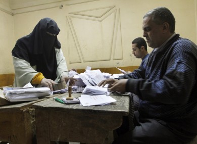 Egyptian referendum officials count votes at a polling station in Cairo after ballots were cast in the referendum on adopting a new constitution.