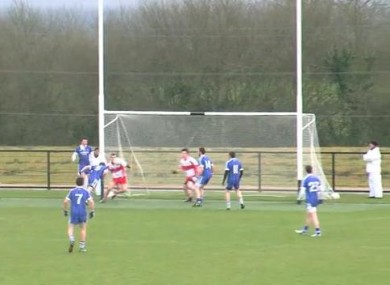 The Ballinderry Shamrocks player heads the ball into the net.