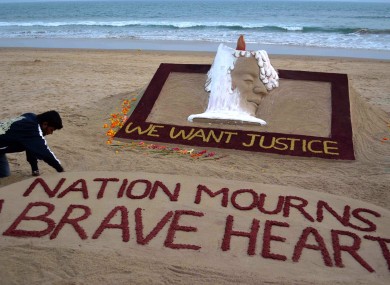 Sand artist Sudarshan Pattnaik creates a sculpture to pay homage to the gang rape victim who died last Saturday in hospital.