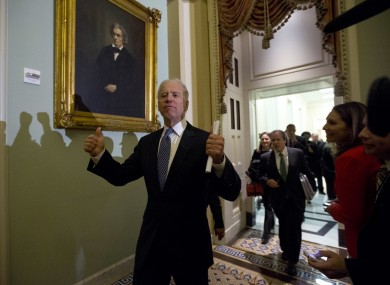 Vice-president Joe Biden gives a thumbs-up to reporters after a meeting of Democratic senators, shortly before the Senate approved a package to avoid the US's 'fiscal cliff'.