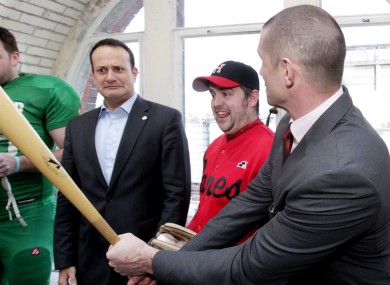 Leo Varadkar meets Munster rugby legend Alan Quinlan (right) and introduces him to the baseball bat of the Dublin City Hurricanes' Peter Kavanagh (centre).