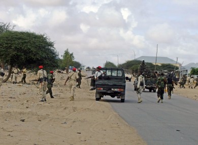 Somali government soldiers take position during a clash with suspected Al -Shabab fighters.