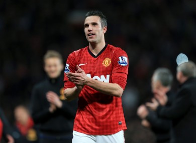 Manchester United's Robin Van Persie celebrates winning the title on the pitch after the final whistle.