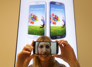 A woman holding the Samsung Galaxy S4 smartphone which went on sale at the Samsung Experience Store in east London
