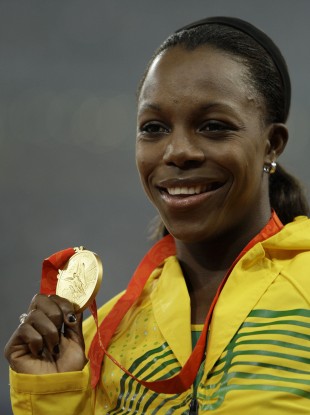 Veronica Campbell-Brown shows her gold medal after the 2008 Olympic 200m final.