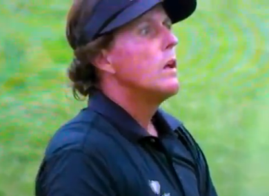 Phil Mickelson watches as his iron approach drops for eagle on 10.