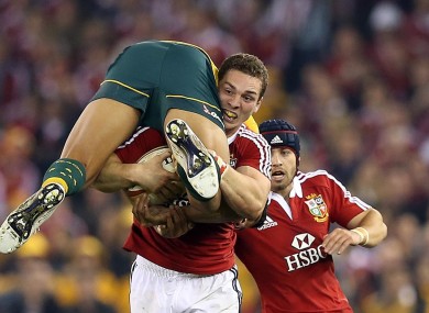 George North takes Israel Folau for a ride in Melbourne.