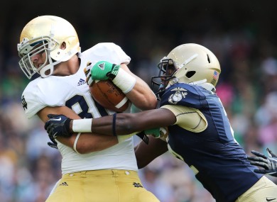 Navy's Parrish Gaines tackles Tyler Eifert of Notre Dame during last year's Emerald Isle Classic.