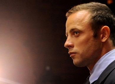 Olympic athlete Oscar Pistorius stands in the dock during his bail hearing at the magistrates court in Pretoria. (File photo)
