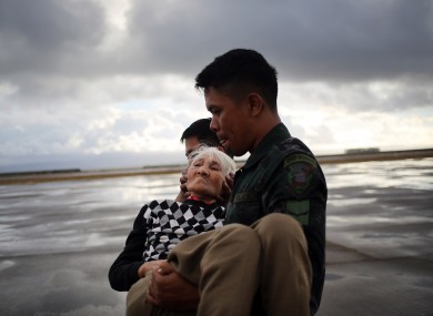 An elderly woman is evacuated from the airport in Tacloban.