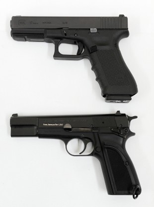 File Photo: A Glock 17 9mm pistol (top) and its predecessor a Browning 9mm.