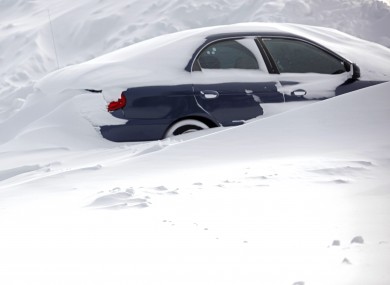 A car in Western Michigan University parking lot remains buried in snow