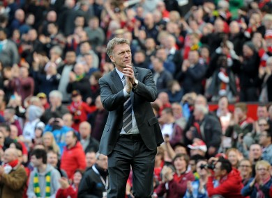 Manchester United manager David Moyes salutes the fans as he leaves the pitch after his team's 4-1 win.