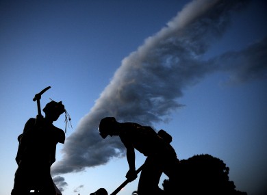 A statue of the town's miners with carnations left on it in Soma, Turkey, early this morning.