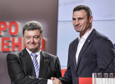 Ukrainian presidential candidate Petro Poroshenko, left, shake hands with Vitali Klitschko.