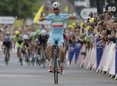 Vincenzo Nibali points to his shirt as he crosses the finish line ahead of the sprinting pack to win the second stage.
